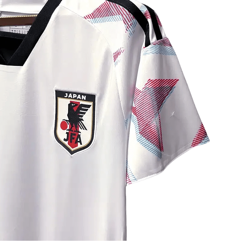 Japan away kit official Adidas design showcasing white colorway with pink sakura graphics and black collar detailing
