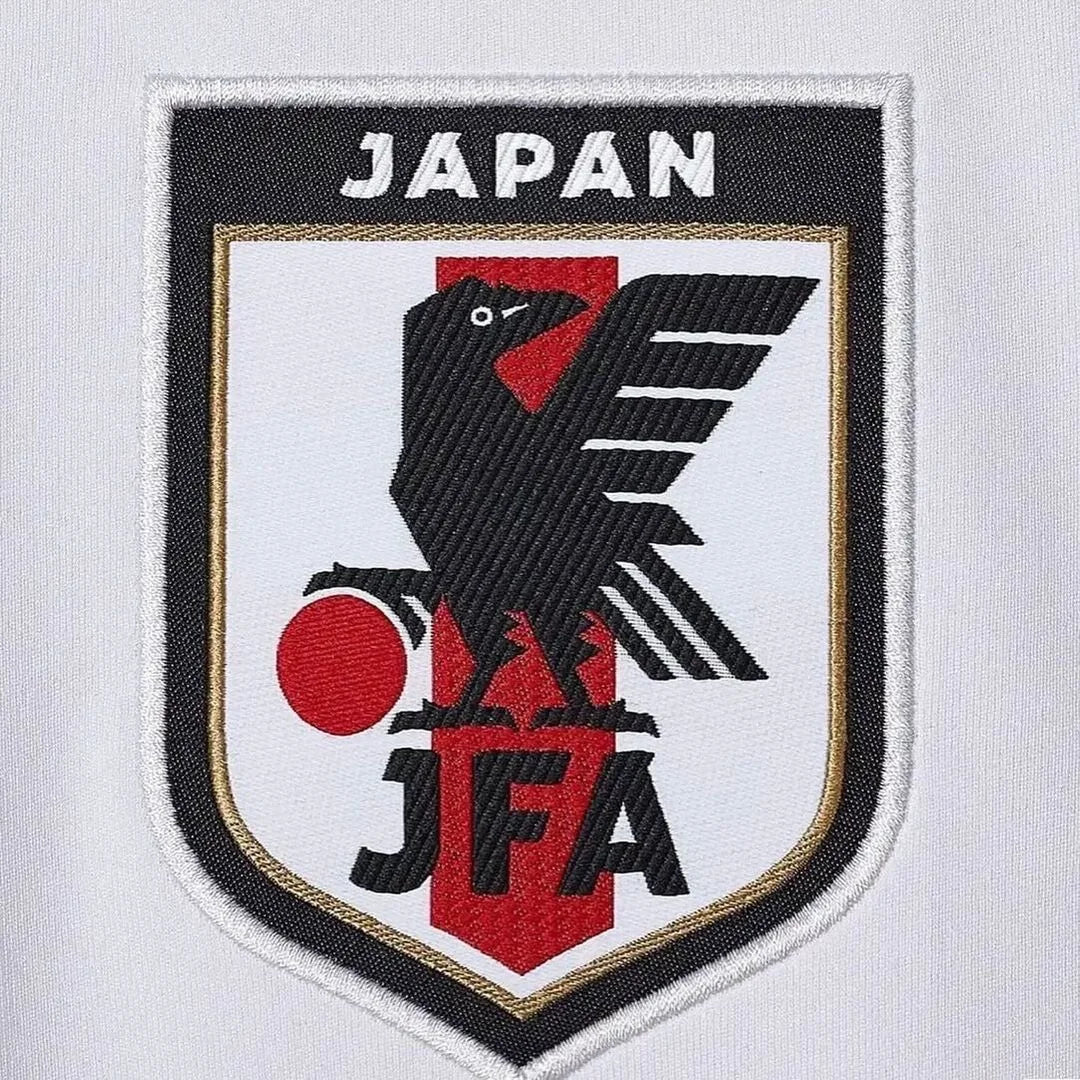 White Japan soccer jersey featuring anime-inspired design with Itachi Uchiha from Naruto, black crows, Konoha symbol, Adidas logo, and Japan national team crest