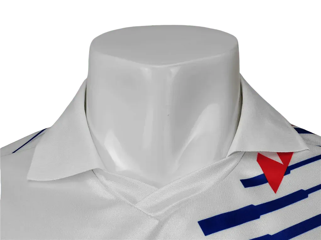 White polo shirt with red and blue accents on a mannequin against a white background