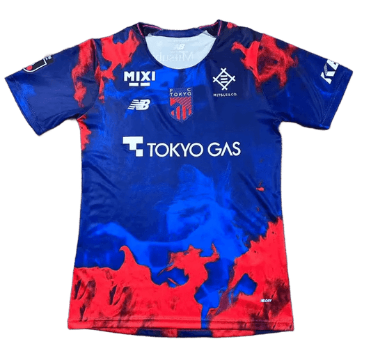 FC Tokyo jersey 2026 home front view deep blue shirt with red smoke graphics, central FC Tokyo crest, Tokyo Gas sponsor text, multiple chest sponsor marks, J.League sleeve patch