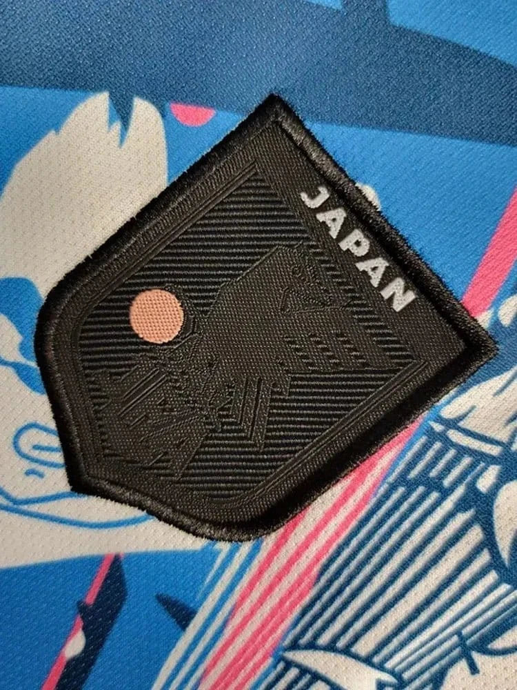 Dragon Ball comic jersey with multiple story panels, white base fabric and vibrant blue and pink character artwork with black v-neck collar