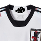 White Japan soccer jersey featuring anime-inspired design with Itachi Uchiha from Naruto, black crows, Konoha symbol, Adidas logo, and Japan national team crest