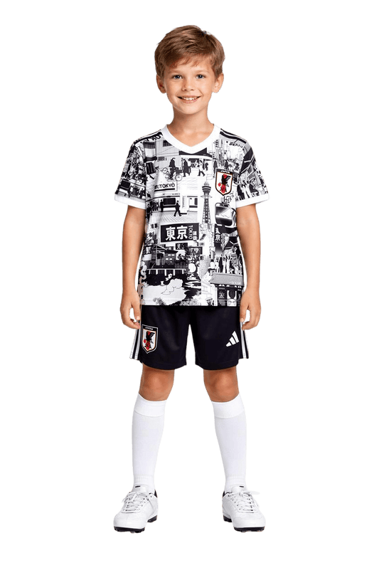 Child wearing a black and white patterned shirt with Adidas shorts on a black background