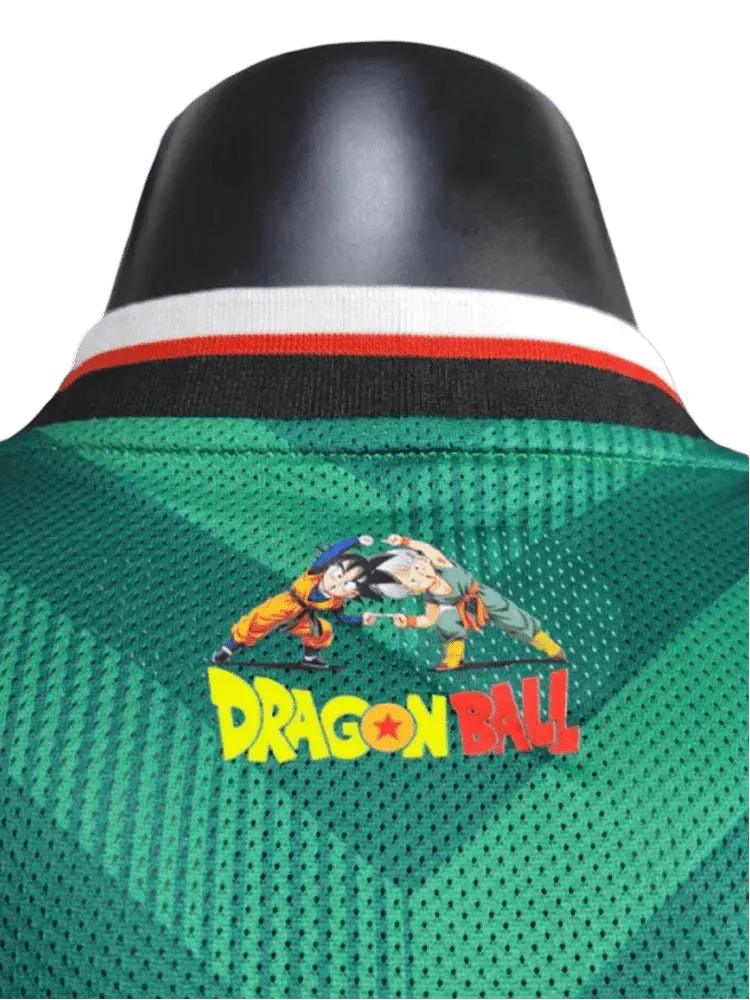 Green Mexico anime soccer jersey featuring zigzag chevrons, V-neck with black trim, and Dragon Ball crest embroidery