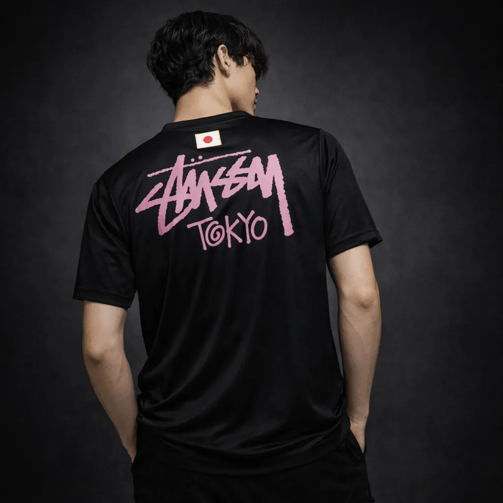 Back model view of black Stussy Japan jersey with pink Stussy Tokyo logo