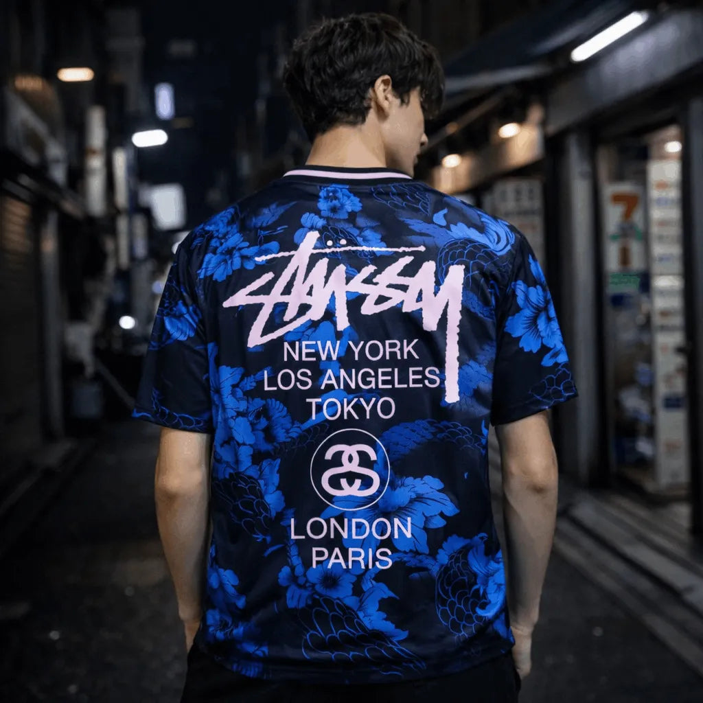 Back view of blue Stussy Japan soccer jersey with large logo and city text print