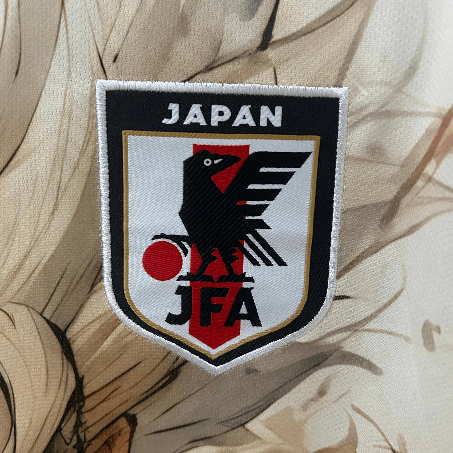 Goku soccer jersey in earth tone beige colors featuring dynamic anime artwork and Japan football badge  