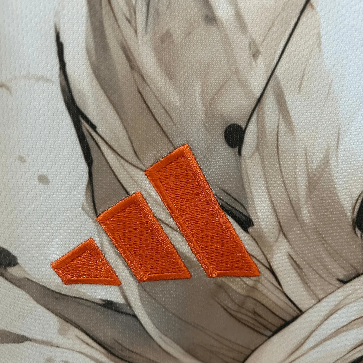 Goku soccer jersey in earth tone beige colors featuring dynamic anime artwork and Japan football badge  
