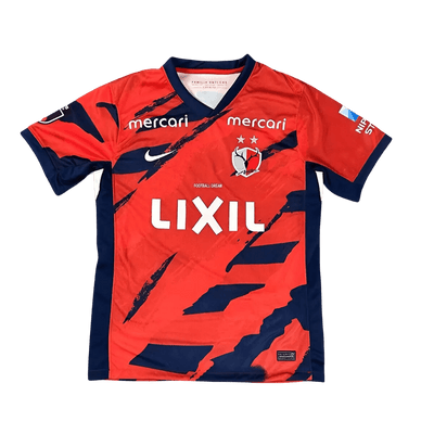 Kashima Antlers 25/26 home jersey front view red football shirt with navy diagonal brush graphics, white LIXIL sponsor, club crest with two stars, Nike logo, J1 League 2025 edition