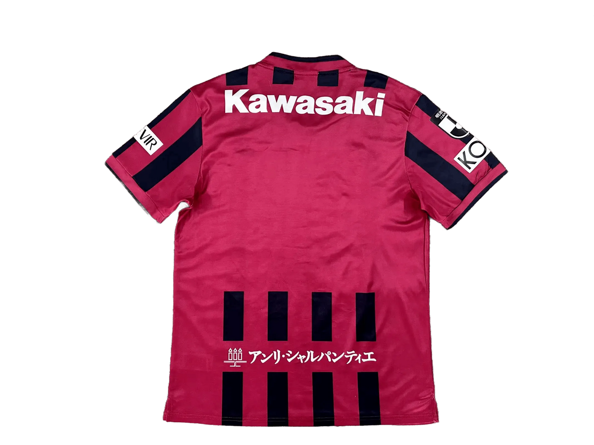 Vissel Kobe 2026/27 home jersey back view, burgundy shirt with black shoulder blocks and large Kawasaki text at upper back, dark vertical stripe elements near lower back